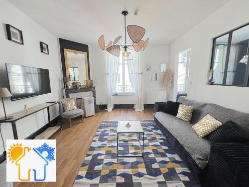 a living room with a couch and a table at Le Relais des Cordeliers in Nancy