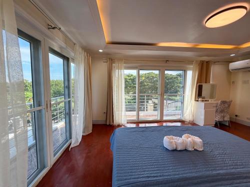 a bedroom with a blue bed with two shoes on it at Dolores Cabin & Breakfast in Mactan