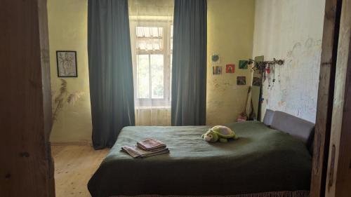 a bedroom with a bed with two stuffed animals on it at Guest house in Ipnari