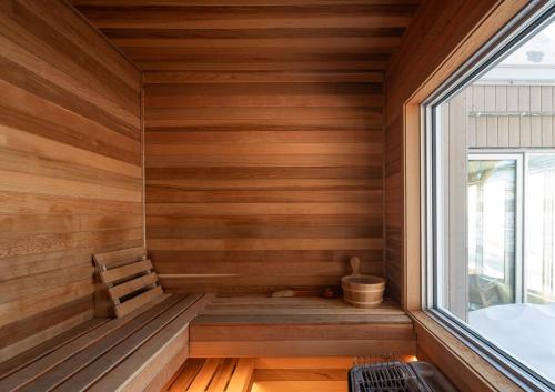 a sauna with wooden walls and a window at VILLA-29 Spa, Sauna, Sunset & Waterfront View in Sainte-Petronille