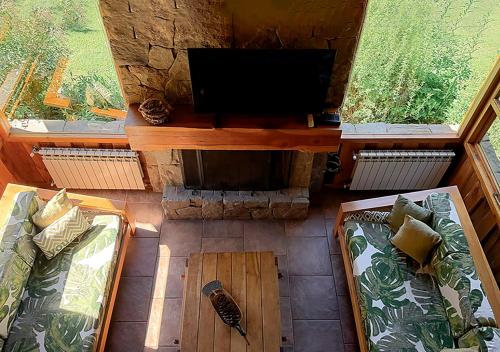 an overhead view of a living room with a tv and couch at Tillka - Casas de Montaña in Villa La Angostura
