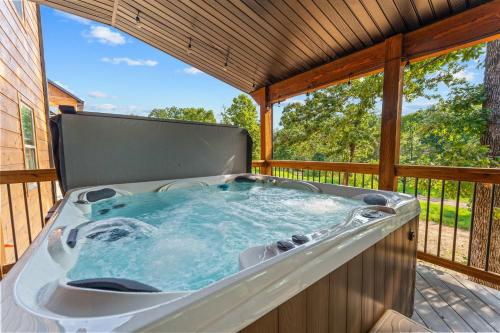 a hot tub on the deck of a house at LakeSides Retreat with Amenities in Hollister