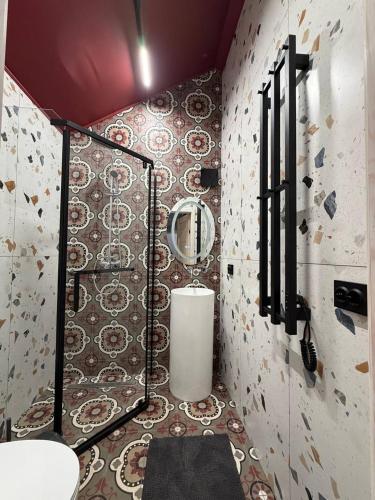 a bathroom with a toilet and a mirror on a wall at My Dream in Antalovtsi