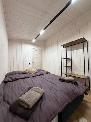 a bedroom with a large bed with purple sheets at My Dream in Antalovtsi