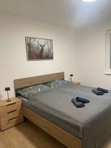 a bedroom with a bed with a deer picture on the wall at Alpinchalet Eisenerz in Eisenerz