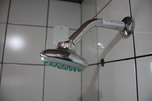 a shower with a shower head in a bathroom at Hotel Somensi in Bento Gonçalves