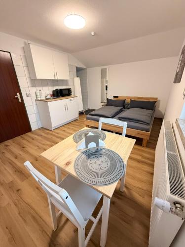 a living room with a table and chairs and a bed at Sleep & Go Höchst in Höchst