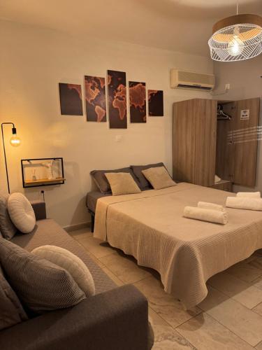 a living room with two beds and a couch at Giannis Philoxenia in Kakí Vígla