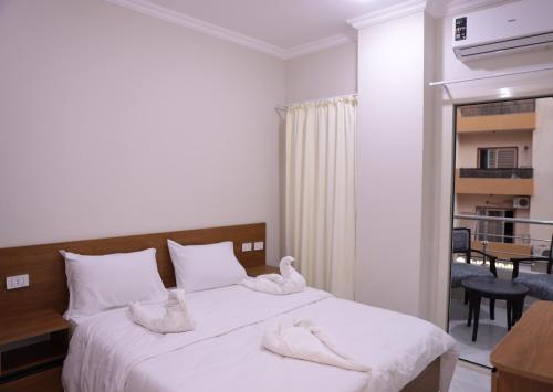a bedroom with a bed with towels on it at جراند فاندا سويتس الغردقه Grand Vanda Suites Hurghada in Hurghada