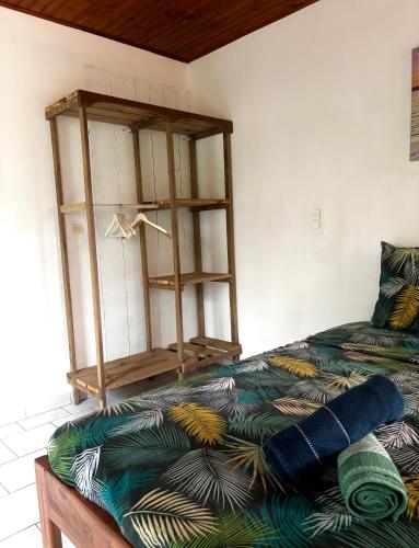 a room with a bed with a shelf on it at Le paradis créole in Sainte-Luce