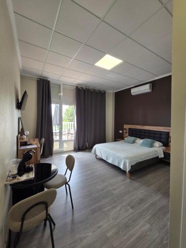 a bedroom with a bed and a table and chairs at Hotel La Oficina in San Miguel de Salinas