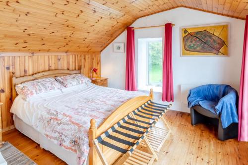 a bedroom with a bed and a window with red curtains at 2 Bed in Cashel oc-i223 in Moyrus