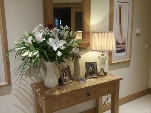 a vase of flowers on a table in a room at Lissadell Lodge in Carney