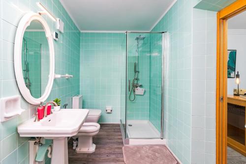 a bathroom with a sink toilet and a shower at La Fuente 33 in Castro-Urdiales