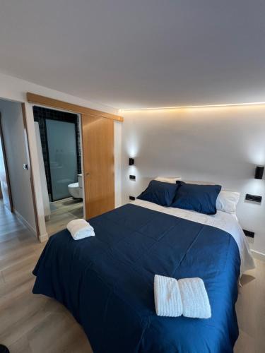 a bedroom with a large blue bed with two pillows at Serena Boutique Duplex in Madrid