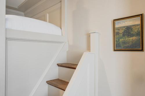 a staircase in a house with a painting on the wall at Hotel Burg in Leesburg