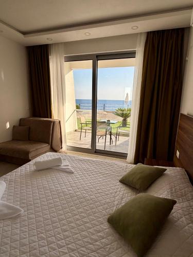 a bedroom with a bed and a view of the ocean at Apartments Komina in Utjeha