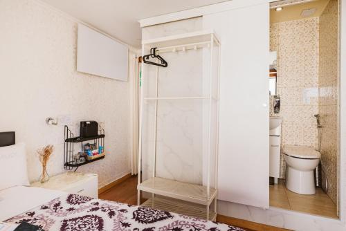 a bedroom with a shower and a bed and a toilet at Charme da Graça - Guest House in Lisbon