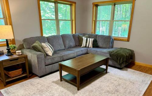 a living room with a couch and a coffee table at Honey Ridge Forest Retreat in South Bloomingville