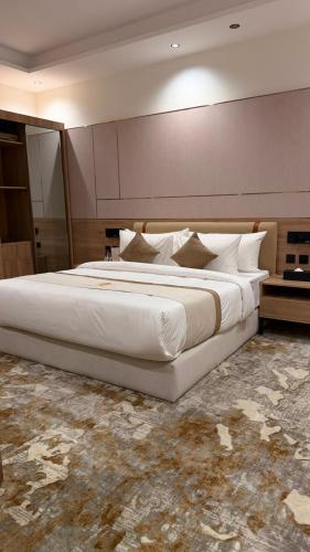 a large white bed in a hotel room at فندق أروف Aroov Hotel in Taif