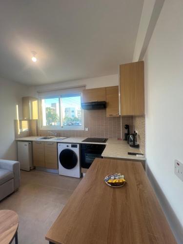 a kitchen with a wooden table with a plate on it at Melissa 2 Block A in Paralimni