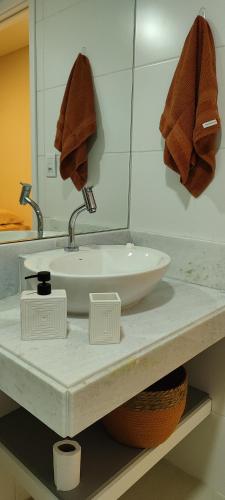a bathroom with a white sink and a mirror at PARK DEL PRADO - Conforto pertinho do mar in Cabedelo