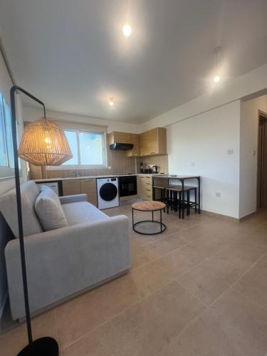 a living room with a couch and a table at Melissa 2 Block A in Paralimni
