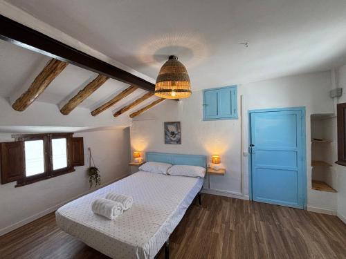a bedroom with a bed and a pendant light at El Rincón de Laura - Quesada in Quesada
