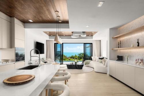 a kitchen with a counter and a living room at Villa Angelina in Leeward