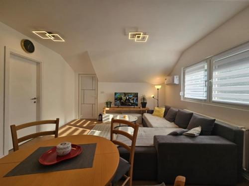 a living room with a couch and a table at Airport Apartment II in Surčin