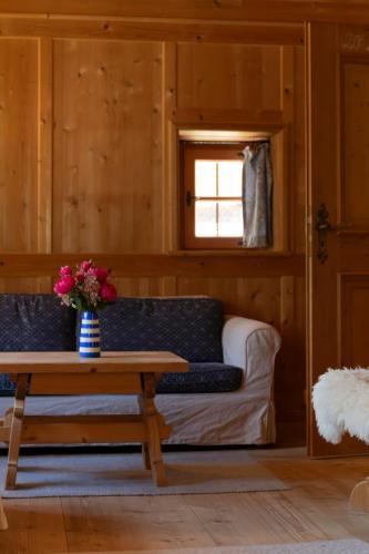 a living room with a couch and a table at Landhaus No 12 mit privater Sauna in Bayrischzell