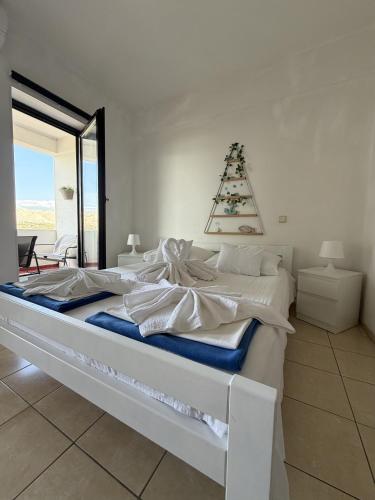 a white bed with a christmas tree on top of it at Apartments Antonio in Pag