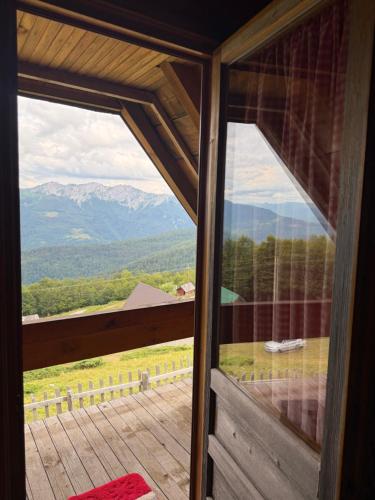 a view of the mountains from the window of a cabin at Planinska Koliba Mo in Katun Božički