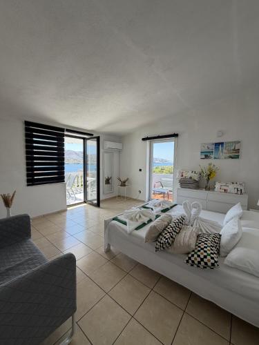 a bedroom with a large bed with a view of the ocean at Apartments Antonio in Pag