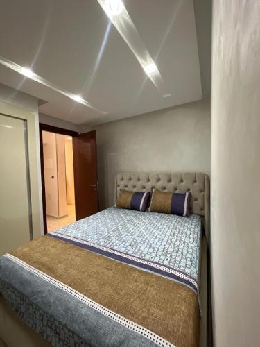 a bedroom with a large bed with two pillows at Mini Villa 2 Al hoceima in Al Hoceïma