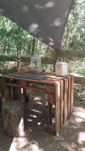 a ping pong table with avertisement at Tentes suspendues D'En Haut in Friaudour