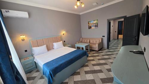 a bedroom with a bed and a chair in a room at Panorama 7 day's in Hacıselli