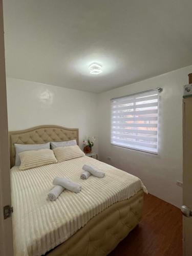 a bedroom with a large bed with two towels on it at Zensean Haven in General Santos