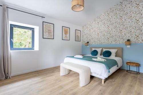 a white bedroom with a bed and a window at Gite De La Borie in Saint-Ignat