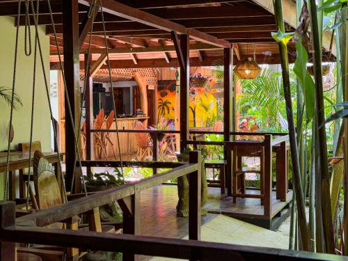 a room with tables and paintings on the wall at Hotel Boutique Casa Mambo in Cahuita