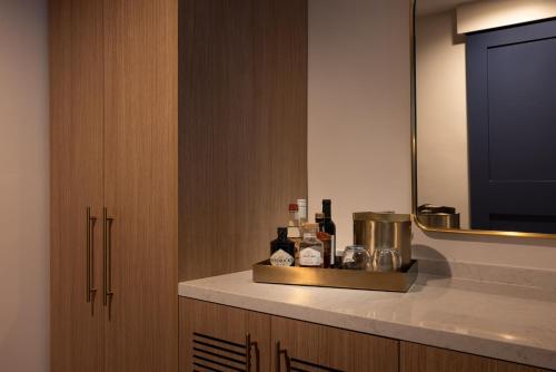a bathroom with a counter with bottles of wine at The Sunny in Sunny Isles Beach