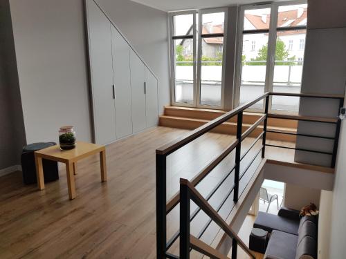 a living room with a staircase and a table at MazuryTime in Mrągowo
