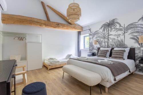 a bedroom with a large bed and a desk at Gite De La Borie in Saint-Ignat