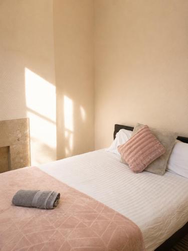 a bedroom with a bed with a pillow on it at 52 - room 2 - smart TV in Swansea