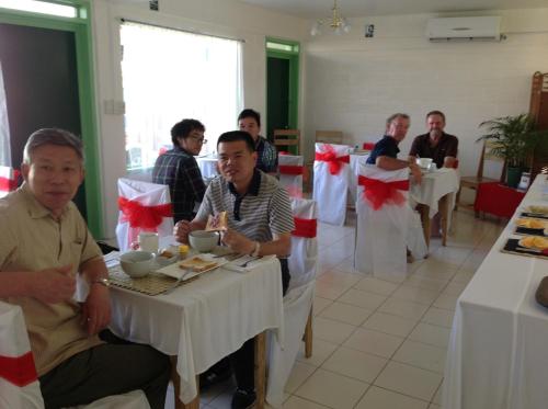 a group of people sitting at tables in a restaurant at Moatoga Hotel in Apia