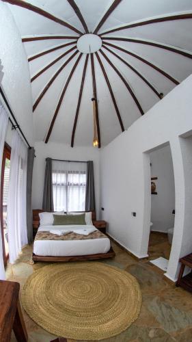 a bedroom with a large bed in a room at Olarashii River Lodge in Arusha