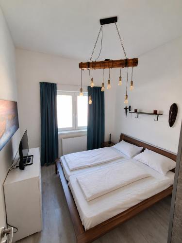 a bedroom with a large bed with blue curtains at Apartment Hofacker in Pernegg an der Mur