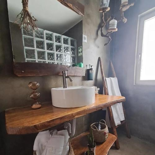 a bathroom with a sink on a wooden table at Casa do Tempo Espinhoso in Vinhais