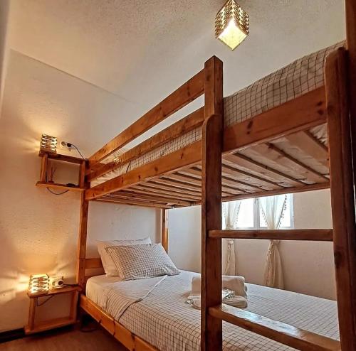 a bedroom with two bunk beds and a window at Casa do Tempo Espinhoso in Vinhais