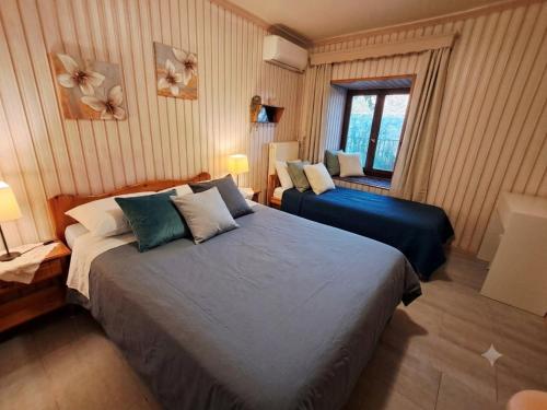 a hotel room with two beds and a window at El-Mi's little house in Theologos in Theológos